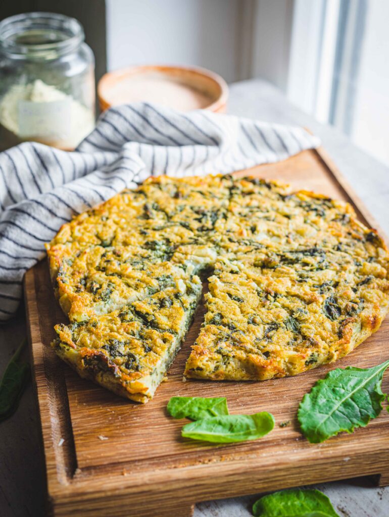farifrittata su tagliere di legno con foglie e canovaccio